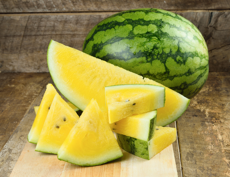 Yellow Watermelon Sliced On Wooden Background