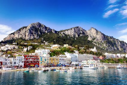 Capri - image of the island seen from the sea, multicolored houses stand out on the coasts
