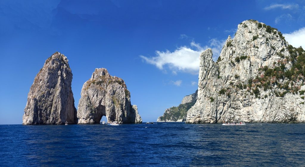Capri - Immagine dei faraglioni che si ergono su un mare blu