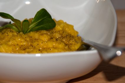 Risotto -Saffron risotto dish with decorative basil leaf