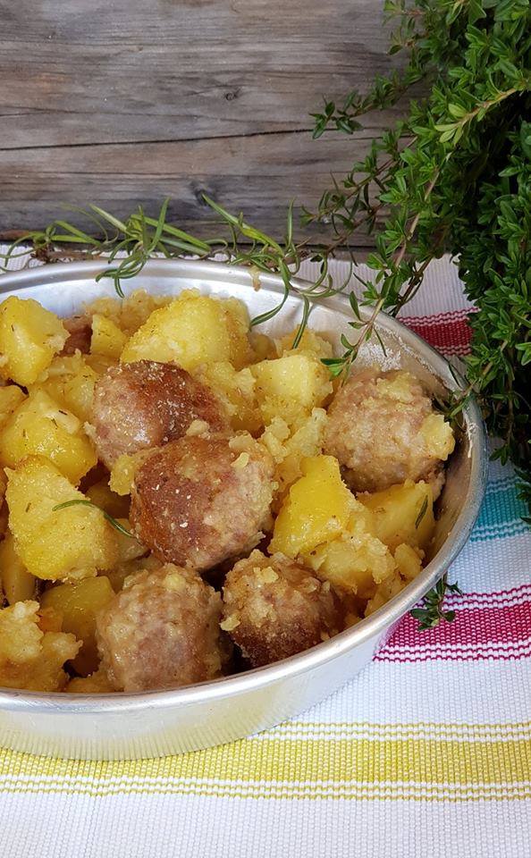 detail of dish with baked meatballs with tasty potatoes