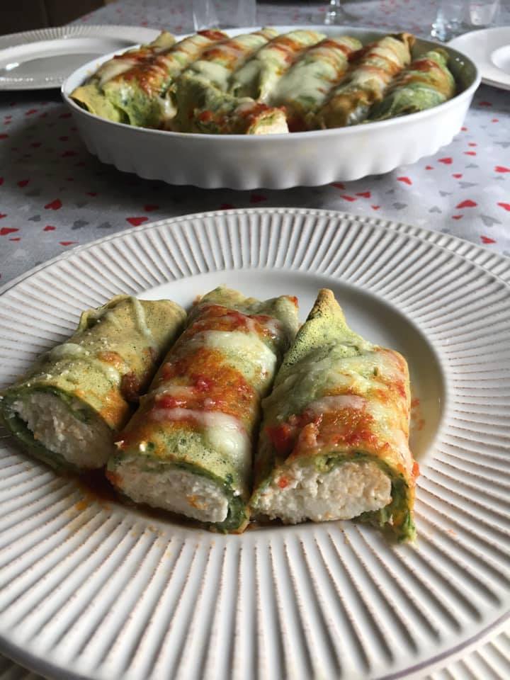 three cannelloni with ricotta and spinach cut in half