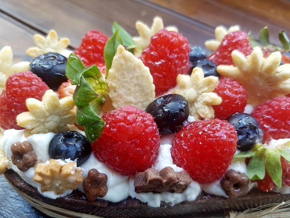 sweet pastry with cream and fruit on top