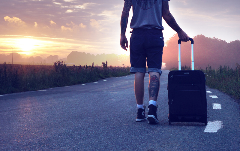 out-of-doors - A boy leaving with a suitcase