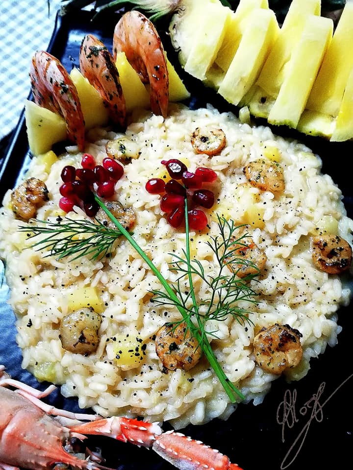 close-up of Risotto with pineapple, prawns and scampi shaded with brandy