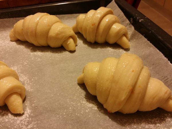 croissants during leavening resting on parchment paper