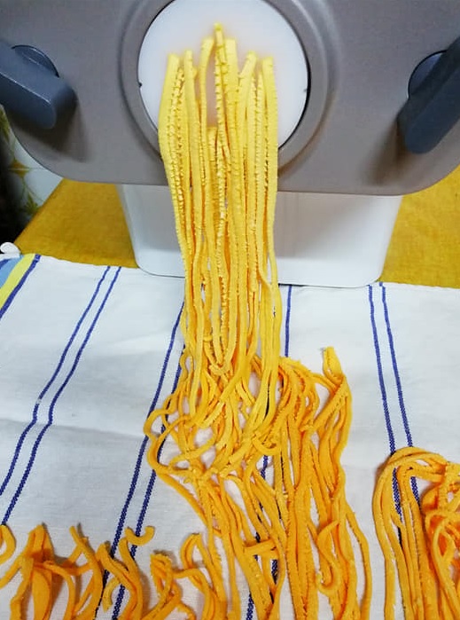 Nests of Italian linguine fries coming out of the pasta maker