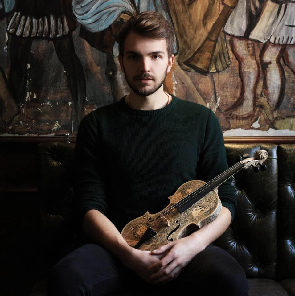 Leonardo Frigo posing with a violin in his arms