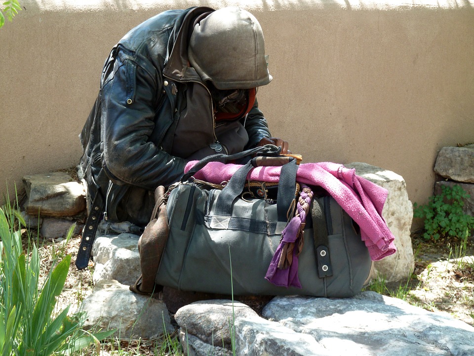 church and a poor man on the street