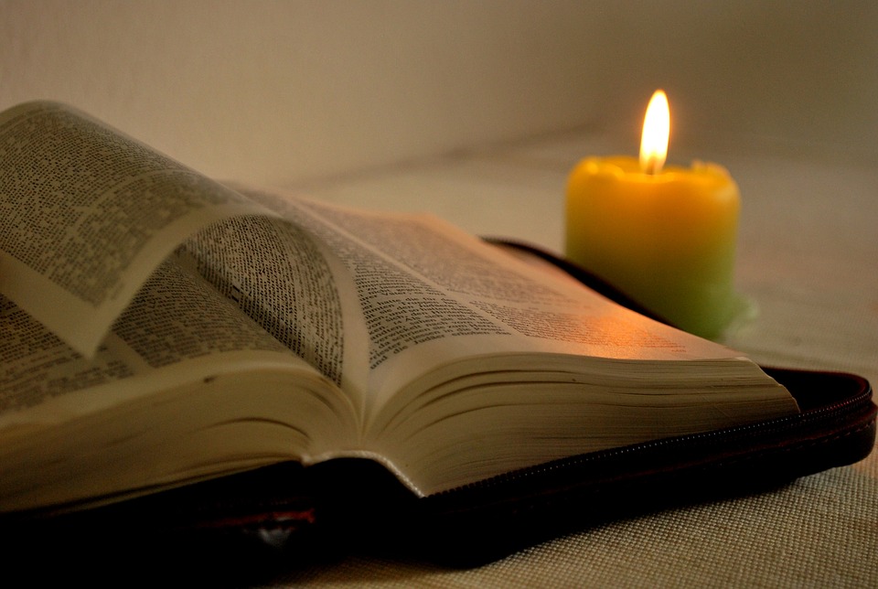 week - open bible with a lit candle beside it - holy week