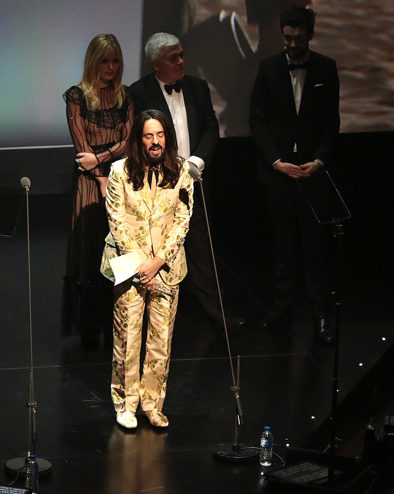 fashion - Alessandro Michele on stage with a gold dress