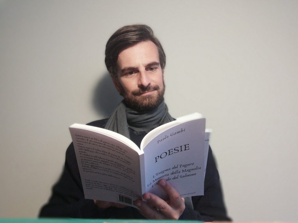 the poet Paolo Gambi while reading his book of poems