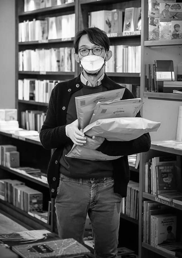 black and white photo of Riccardo with mask and envelopes