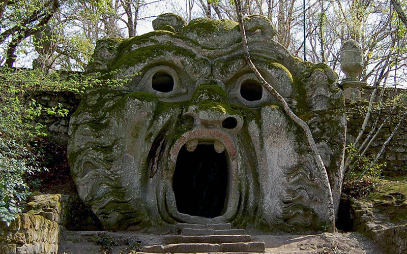 museums - stone entrance in the shape of a mouth in the park of monsters in Bomarzo