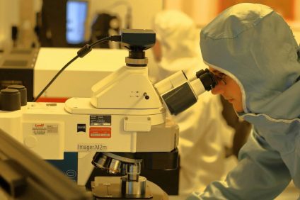 Italian vaccine - Researcher analyzes viruses under a microscope