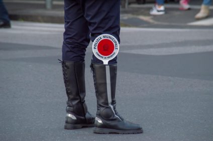 Italy from 7 January - Legs of a policeman with a red paddle inside the boot