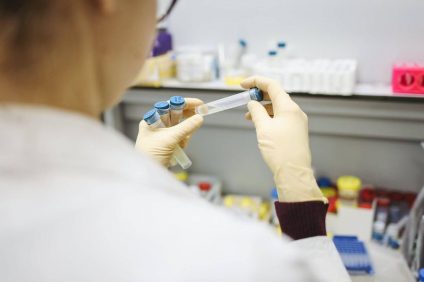 Monoclonal antibodies - female doctor examines test tube